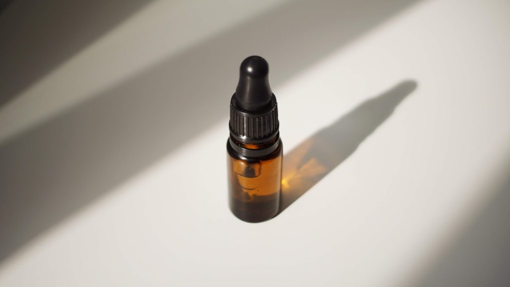 a bottle of essential oil sitting on a table